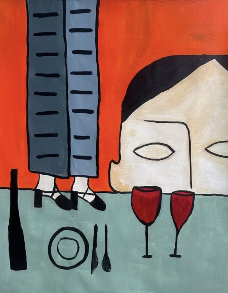 A face peeking over a table set with two red wine glasses, legs in grey trousers behind, orange ground