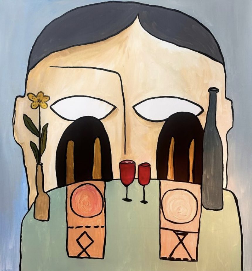 A giant face behind a table with two wine glasses, a bottle and a flower