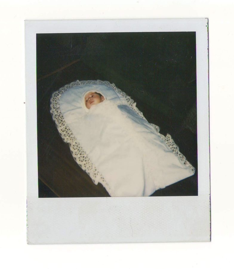 Old Polaroid of Ani as a newborn, wrapped in a white lace blanket